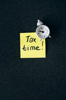 A clock on a sticky note with 'Tax time!' emphasizes importance of tax deadlines.